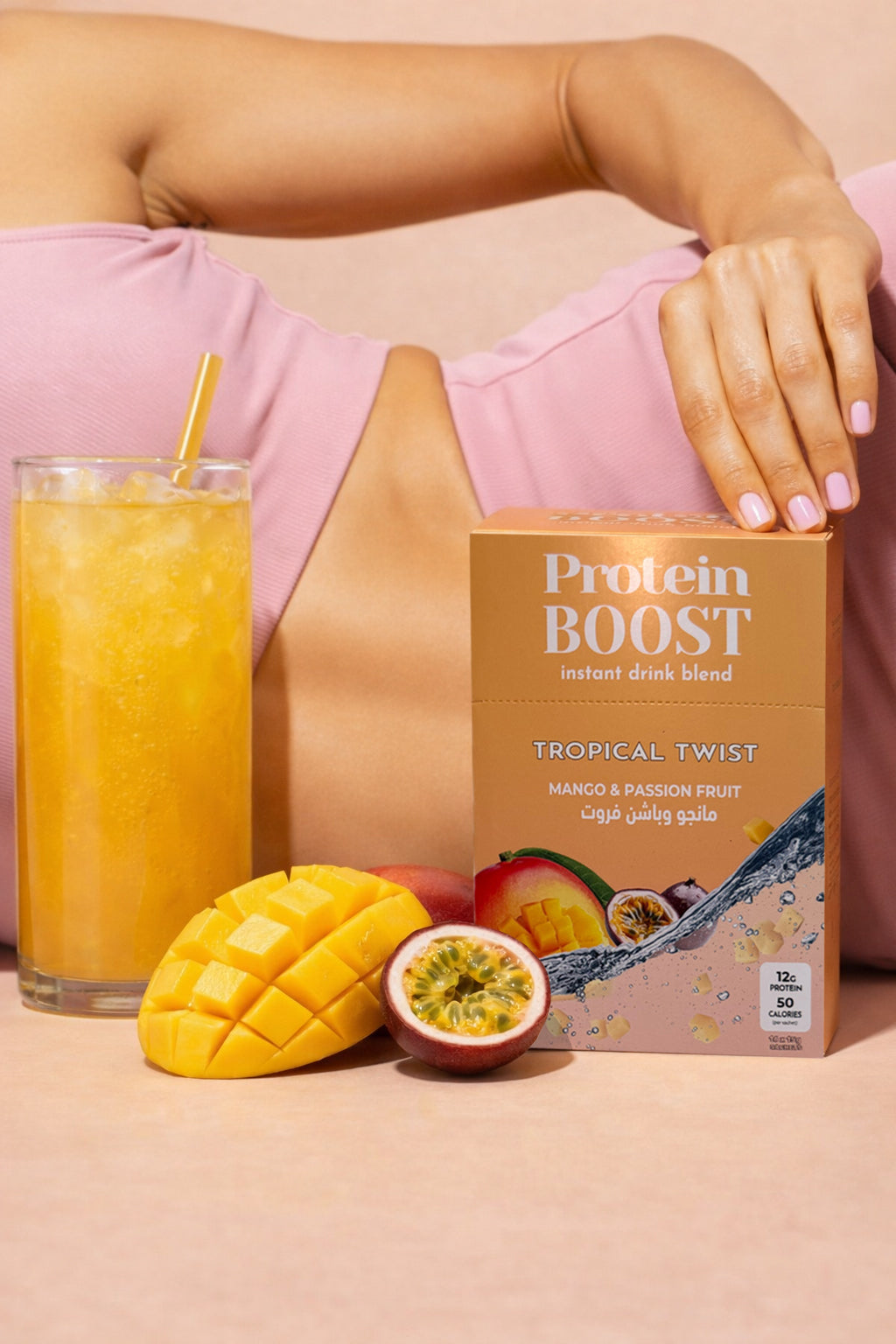 Protein boost package with a glass of juice, mango, and passion fruit on a peach background