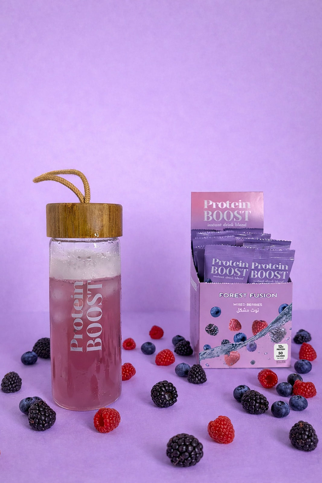 Protein boost Mixed Berries drink glass with wooden lid, protein powder packets, and berries on a purple background